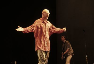Full length of man wearing mask against black background