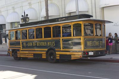 Bus on street by buildings in city