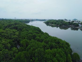 High angle view of trees by lake against sky