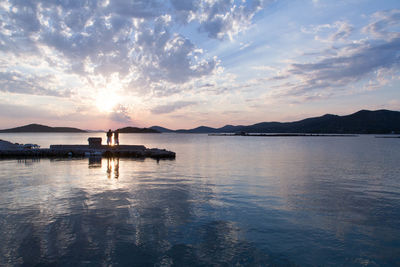 Scenic view of lake against sky during sunset