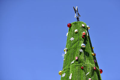 Low angle view of christmas tree against clear sky