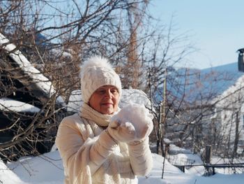 Young woman standing on snow