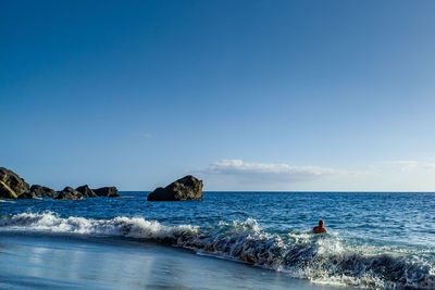 Scenic view of sea against clear blue sky