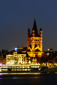 Illuminated building against sky at night