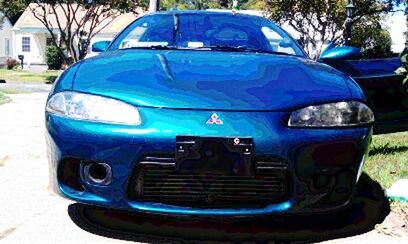 Close-up of blue car on street