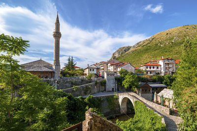 The bridge kriva cuprija and a mosque in mostar, bosnia and herzegovina