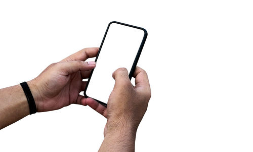 Midsection of man holding smart phone against white background