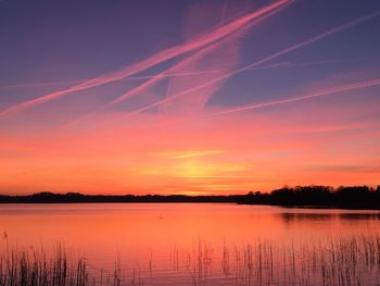 Scenic view of lake against romantic sky at sunset