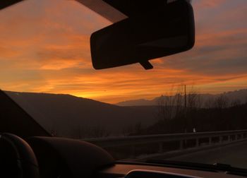 Silhouette car against sky during sunset