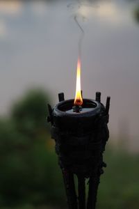 Close-up of lit candle against blurred background