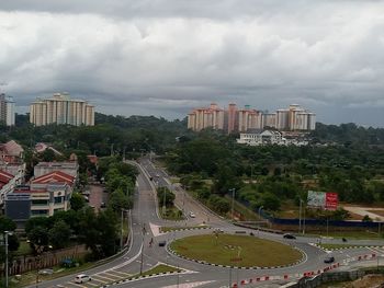 View of cityscape against cloudy sky