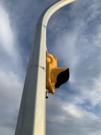 Low angle view of yellow pole against sky