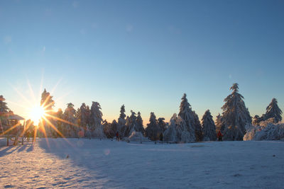 Scenic view of snowcapped field against sky during winter