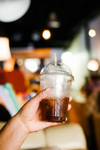 Close-up of hand holding wine glass