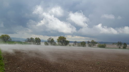 Empty road against cloudy sky