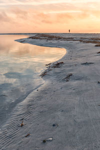 Scenic view of beach against sky during sunset