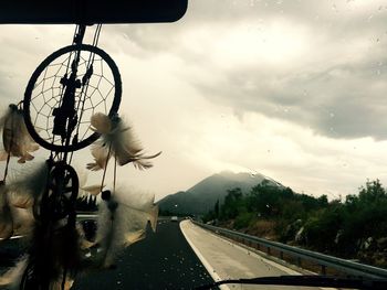 Empty road with mountain range in background