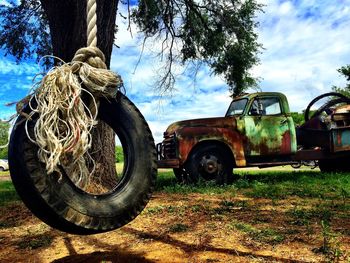 Abandoned truck on field against sky