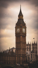 Clock tower in city against sky