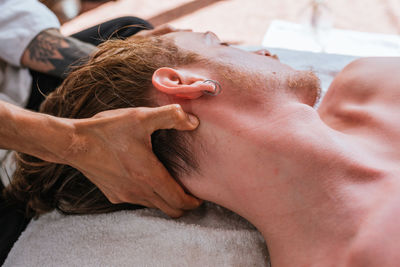 Close-up of shirtless man lying down