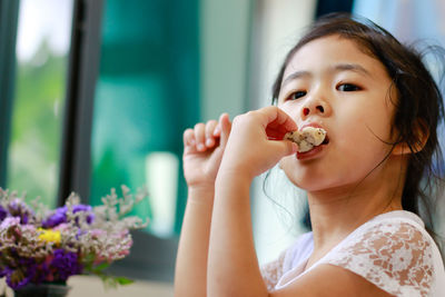 Portrait of cute girl eating food