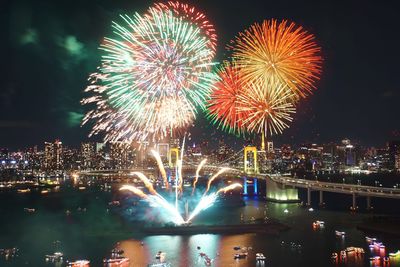 Firework display over river at night