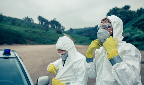 Scientists wearing protective workwear while standing outdoors