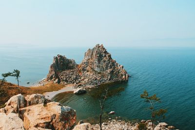 Rock formations in sea against sky