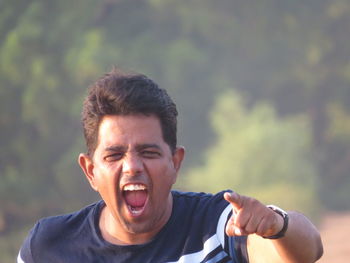 Portrait of young man screaming outdoors