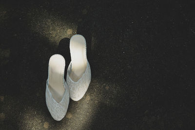 High angle view of white shoes on rock