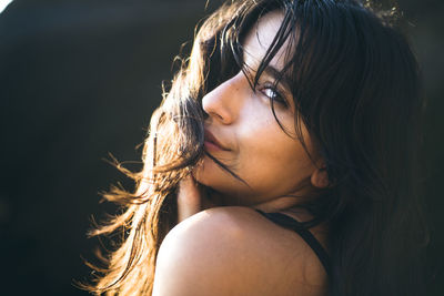 Young latina woman portrait at golden hour in summertime