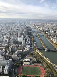 High angle view of river amidst buildings against sky