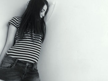 Midsection of woman standing against wall