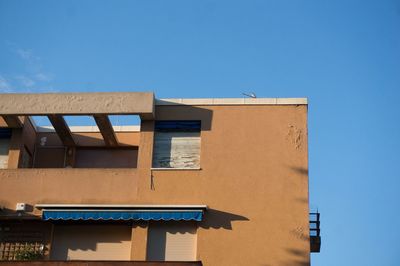 Low angle view of building against clear blue sky