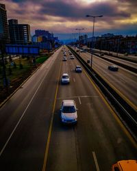 Cars on road in city during sunset