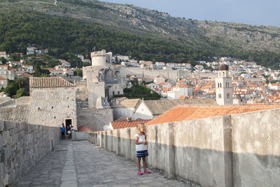 People on wall of building in city