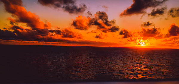 Scenic view of sea against romantic sky at sunset