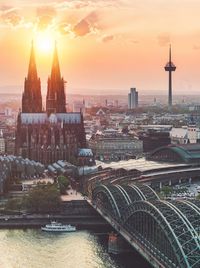 Aerial view of buildings in city during sunset