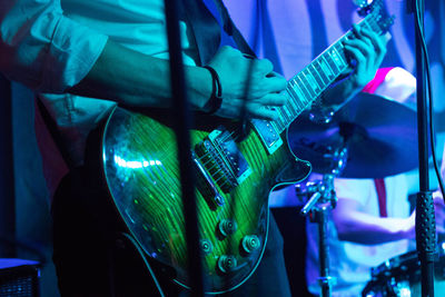 Close-up of man holding guitar