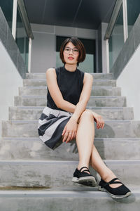 Portrait of woman sitting on staircase