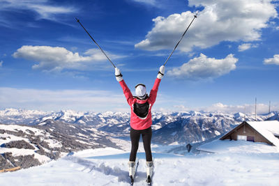 Full length of person standing on snow covered landscape against sky