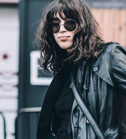 Portrait of young woman wearing sunglasses outdoors