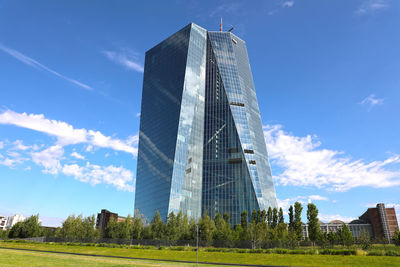 Low angle view of buildings against cloudy sky