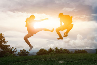 Friends jumping at sunset