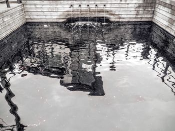 Reflection of building in puddle