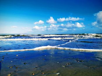 Scenic view of sea against blue sky