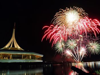 Firework display over river at night