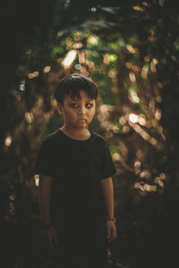 Portrait of boy standing outdoors