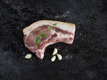 High angle view of pork chop on stone