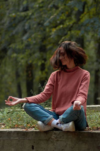 Young woman sitting on field